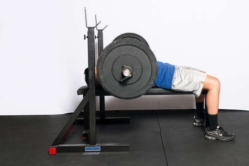 Continue to lower the bar until it lightly touches your chest. It should not hit your chest or bounce off it.