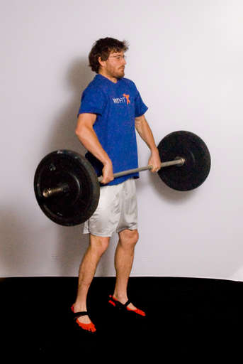 As the barbell reaches mid-thigh, jump upward by extending your hips, legs and ankles. Most of the power for the lift should come from your hips and legs, not from your arms.