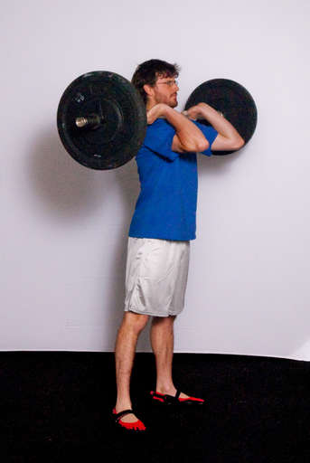 Extend your legs and hips to stand straight up. This concludes the Clean portion of the lift.