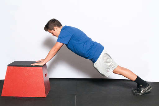 Position yourself in a push up position. Place your hands on a raised object, such as a box or bench. Your body should be in a straight line.
