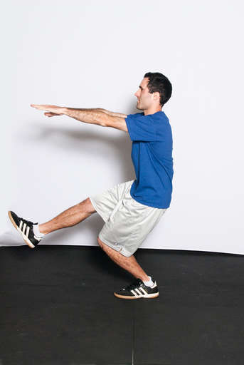Begin to bend your squatting leg down towards the ground, keeping the right leg completely off the floor. Keep the weight of your body on your heel.