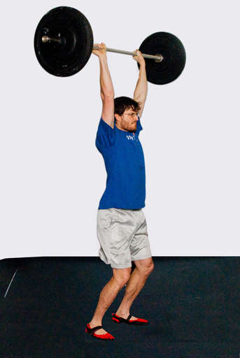 Catch the bar with your arms fully extended and you knees slightly bent.