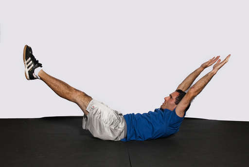 Lift your upper body off the floor at the same time you lift your legs straight off the floor.