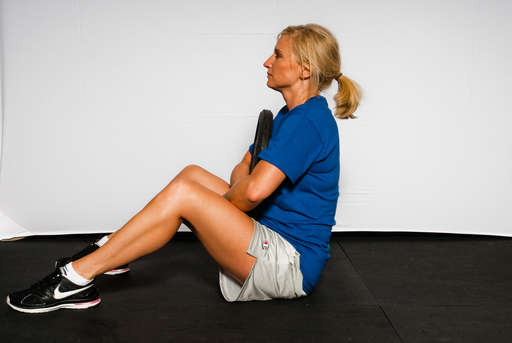 Continue lifting your upper body until you are sitting straight up.
