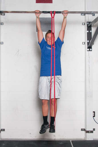 Grasp the pull up bar with an overhang grip and place your feet in the elastic band or on the foot platform. Hang from the bar with your arms completely straight.
