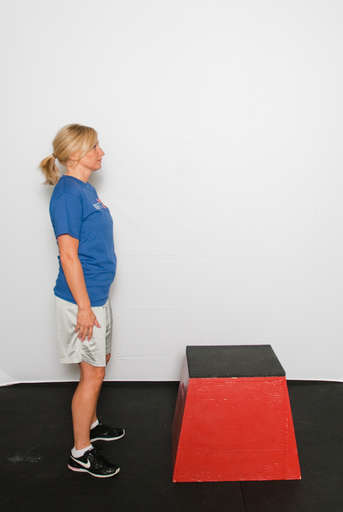 Stand approximately 1 foot away from the box with your legs shoulder-width apart and with a slight bend in the knee. Your arms should hang loosely by your sides.
