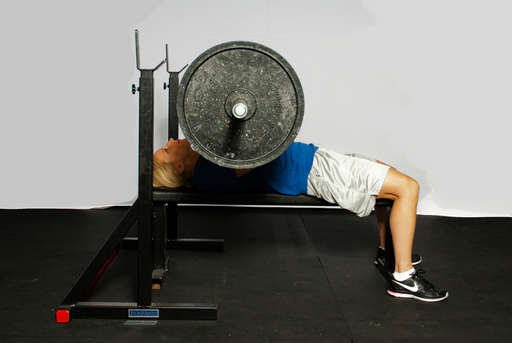 Bend your elbows and lower the barbell toward your chest.