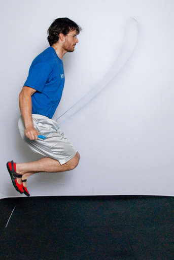 Jump high into the air as you rotate the jump rope around. You may find it helpful to tuck your feet.