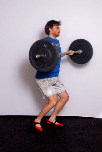 As the bar is moving up, pull your body under the bar by bending and lifting your elbows. 