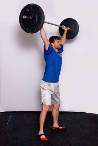 Finish by fully extending your legs while holding the bar overhead.