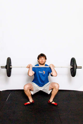 Catch the bar on your shoulders while at the same time moving into a [Front Squat]. Your feet should move out slightly so you land with your feet shoulder width apart. Make sure you keep your elbows up.