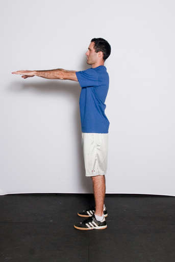 Stand with your feet approximately shoulder width apart and your hands on your hips or extended out in front of you.