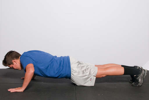 Bend your elbows, lowering your entire body towards the floor.