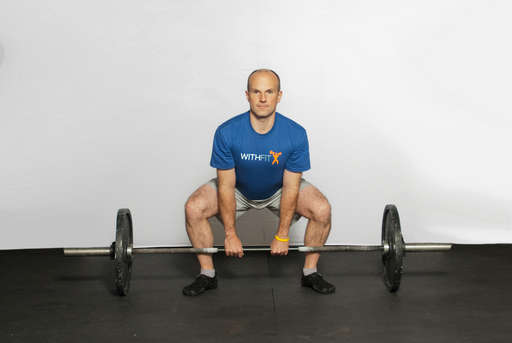Bend at the knees and waist to grasp the barbell using an overhand or alternating grip. Ensure that your back is arched.

