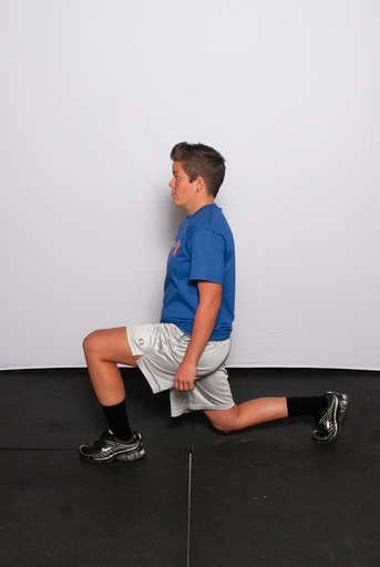Bend the knee of your front leg until your thigh is parallel with the ground as you also bend the back leg so that the knee comes down towards the ground. The back leg should be balanced on the toes.
