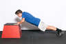 Bend your elbows, lowering your entire body towards the box. Your body should be in a line, with your back straight. 