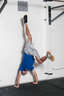 Kick your legs up into a handstand. If you cannot do a freestanding handstand, use a wall for support.