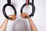 Place your hands on the rings in a false grip. A false grip is achieved as placing your wrists on the rings with your fingers pointing inward, then turning the fingers towards your body and grasping the rings while keeping your wrists on the rings. This grip will feel awkward and uncomfortable at first, but it is important to doing proper muscle ups.