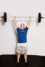 Finish by fully extending your legs with the bar still overhead.