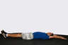 Lie flat on your back on the floor with your legs completely straight, arms stretched over your head.
