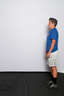 Stand with your feet approximately shoulder width apart and your arms down at your sides or back behind your head.

