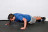 Bend your elbows, lowering your entire body towards the floor. Your body should be in a line, with your back straight.